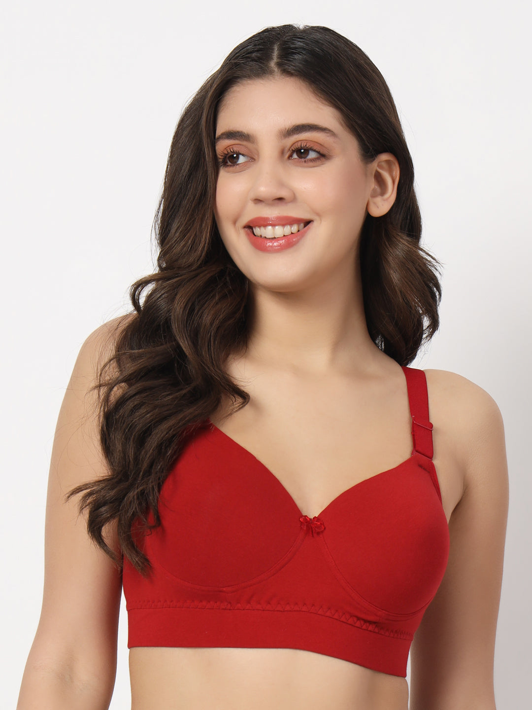 A woman is wearing a red padded bra with a V-neckline and sleeveless design.